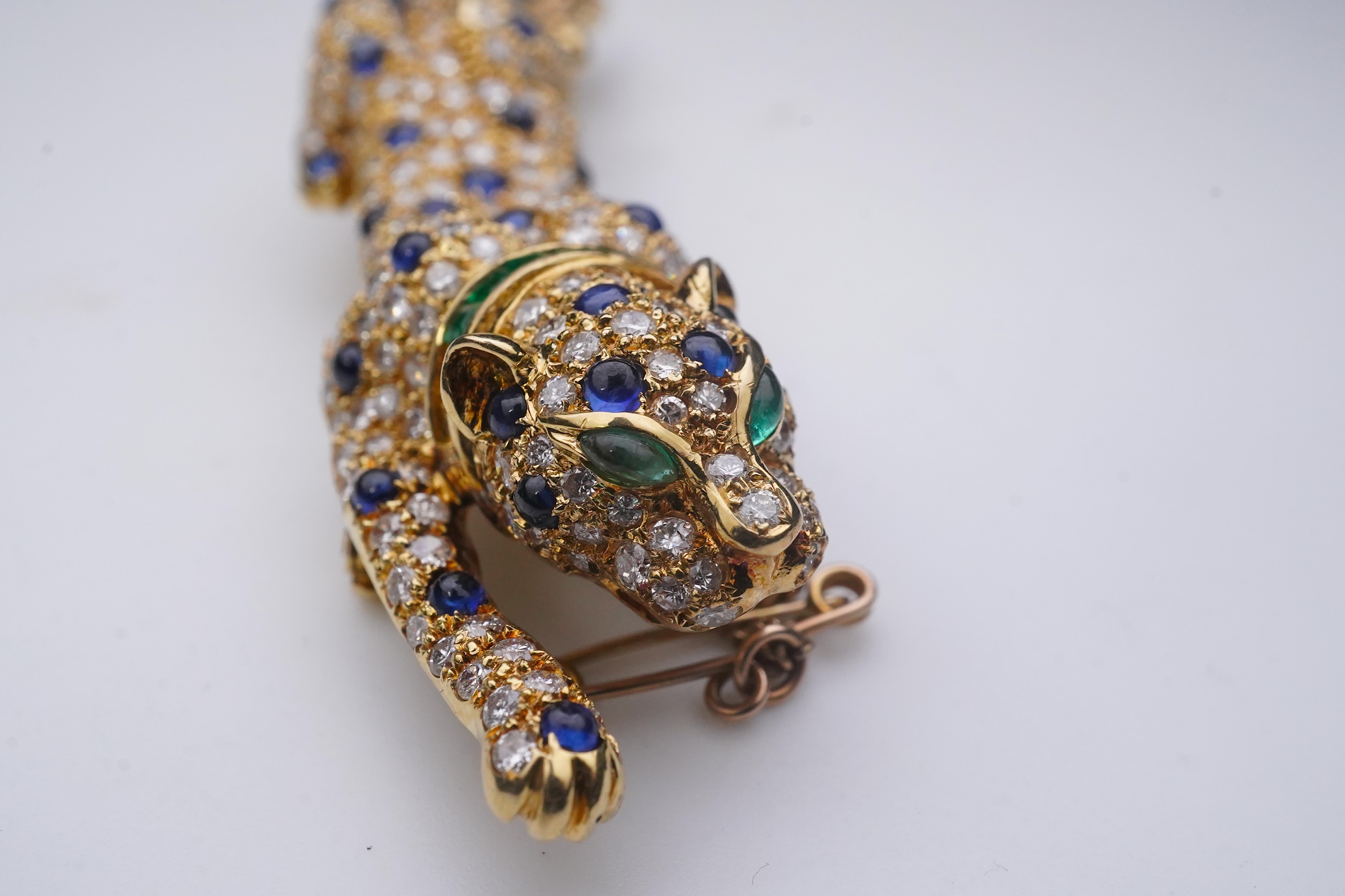 A sapphire, emerald and diamond brooch